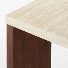 a close up view of a marble top on a wooden table