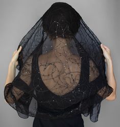 This black shawl is made of chiffon and embroidered with Sequins patterns. This Chiffon shawl will add a sophisticated accent to wear. This Chiffon cape is a trend and makes a great gift for her or you. This  Chiffon scarf black can be worn as a Sequins scarf, a Hair Bandana, or a Black headscarf. It all depends on your mood. The length of the scarf is 55 inches/ 140 cm You can choose the width: 31.5 Inches / 80 cm 23.5 Inches /60 cm 15.5 Inches /40 cm Handmade item The product manufacturing takes 3-5 working days Please note that the color may slightly vary due to photographic lighting sources or your monitor settings. Check my other listings to see more sizes and colors. The link is: https://www.etsy.com/shop/MokushArt?section_id=25647960 Sheer Fitted Party Dupatta, Sheer Fitted Elegant Dupatta, Fitted Sheer Elegant Dupatta, Elegant Shawl-shape Dupatta For Celebration, Elegant Shawl Dupatta For Celebration, Elegant Dupatta Shawl For Celebration, Elegant Fitted Sheer Dupatta, Elegant Celebration Dupatta, Black Silk Dupatta For Wedding