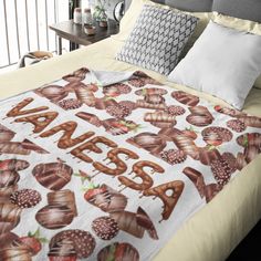 there is a bed that has an image of chocolates on it and the words sweet written in large letters