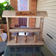 a wooden sign that says fly'n snack bar sitting on top of a glass table