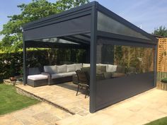 a covered patio with couches and tables