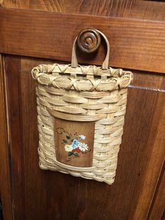 a basket hanging on the side of a wooden door