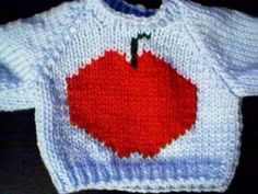 a knitted sweater with an apple on it