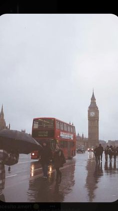 people walking in the rain with umbrellas near big ben