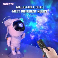 a person holding a remote control in front of an image of a spaceman with the words, adjustableable head meet different needs through the stars