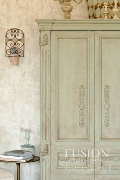 an antique white armoire in a room