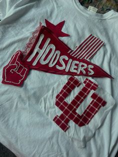 a t - shirt with the word hosiers on it is laying on a table