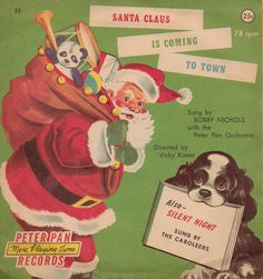 an advertisement for santa claus is coming to town with a black and white dog sitting next to him