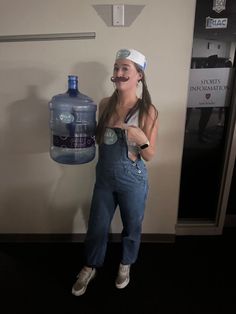 a woman standing next to a water bottle