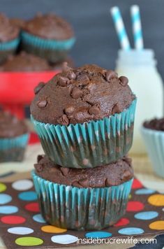 three chocolate muffins stacked on top of each other