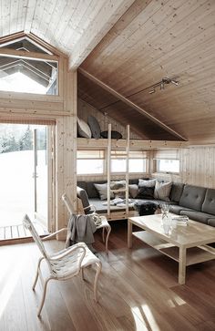 a living room filled with furniture and wooden walls