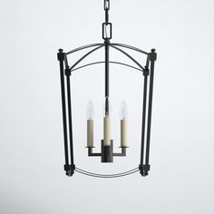 three candles are hanging from a metal light fixture