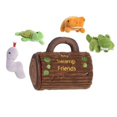 several stuffed animals are in front of a bag with the words swamp friends written on it