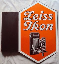 an orange and white sticker with the words leiss iron on it's side