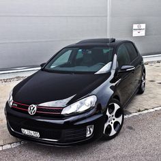 a black car parked in front of a building