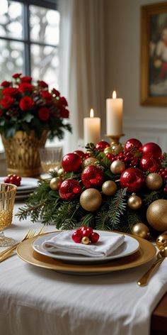 a christmas table setting with red and gold decorations