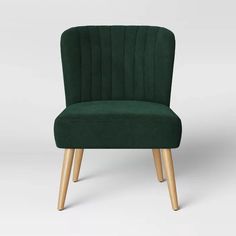 a dark green chair with wooden legs and an upholstered back rest on a white background