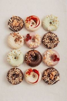 there are many donuts with different toppings on them