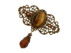 This elegant hair clip is a beautiful accessory for the antique style and is also very suitable for braids or festive updos. The hair accessory is made of bronze-colored metal. In the middle there is a jewelry setting with a tiger eye gemstone cabochon. The side parts of the hair clip are decorated with high-quality brown rhinestones. A jewelry pendant with a faceted glass teardrop bead in brown is attached to the bottom of the hair clip. The hair clip, including the teardrop pendant, measures 5 Braid Hair Accessories, Gemstone Hair, Bride Wedding Gift, Accessories Bride, Elegant Hair, Wedding Gifts For Bride, Bride Hair Accessories, Braid Hair, Tigers Eye Gemstone