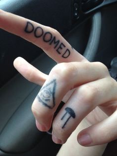 two fingers that have tattoos on them