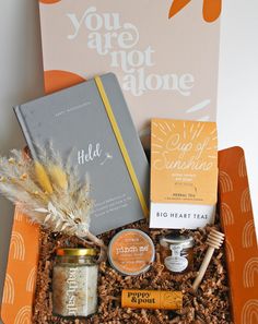 an orange box filled with lots of different items