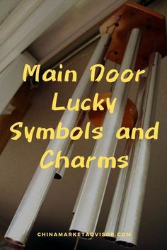 the words main door lucky symbols and charms are in front of an image of a wind chime