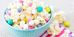 a blue bowl filled with white chocolate and candy