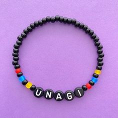 a black beaded bracelet with the word unagi written on it and multicolored beads