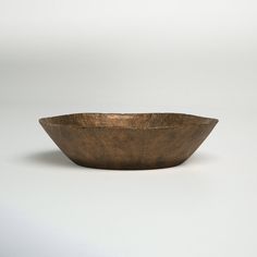 a brown bowl sitting on top of a white table