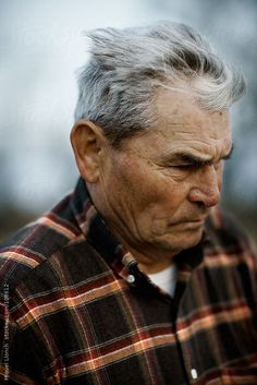 an old man with grey hair looking at his cell phone by jovan rijec for stocks on artfire