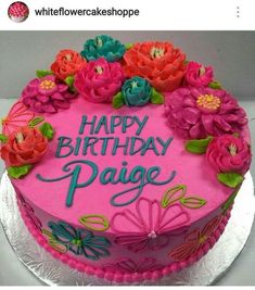 a birthday cake decorated with flowers and the words happy birthday pajage