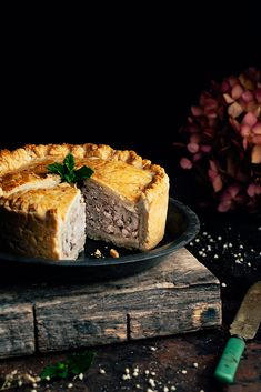 a piece of pie on a plate next to a knife