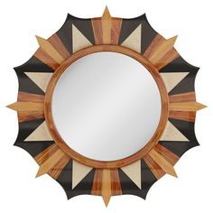 a round mirror sitting on top of a wooden table