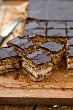 pieces of cake sitting on top of a wooden cutting board