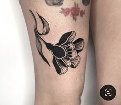 a black and white flower tattoo on the leg