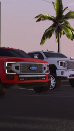 several trucks parked in a parking lot next to a palm tree at sunset or dawn