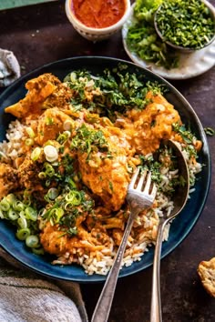 a blue plate topped with chicken and rice