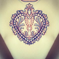 a woman's chest with an intricate design on it