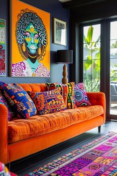 a living room with orange couches and paintings on the wall above them, along with colorful rugs