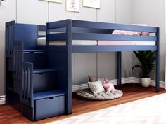 a blue bunk bed with stairs next to it and a plant in the corner on the floor