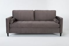 a gray couch sitting on top of a white floor