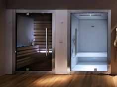 an open door leading to a sauna room with wooden floors and white walls,