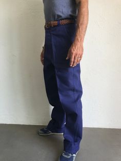 "French blue work trousers - Macober Made in France 1970s High waist pants in indigo blue sanforized cotton . Straight cut with crease. 5 button closure. Bakelite buttons. All originals. 2 side pockets, 1 buttoned back pocket. 5 belt loops. In perfet condition. New item. Deadstock With original cardbord label . Never washed. Label size: 42/10 The model usually wears a size M (40/42) and measurs 175cm - 68,8,\" Measurements (flat): Waist: 40cm - 15,7\" Hips: 57cm - 22,4\" Crotch: 34cm - 12,5\" fr Relaxed Fit Blue Cargo Pants With Belt Loops, Retro Blue Straight Leg Pants, Retro Blue Bottoms With Pockets, Retro Style Denim Blue Cotton Pants, Cotton Work Pants With Belt Loops, Indigo Cotton Bottoms With Belt Loops, Indigo Straight Leg Pants With Belt Loops, Navy Straight Work Pants With Pockets, Vintage Relaxed Fit Pants With Side Pockets