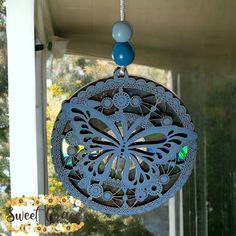 a decorative wind chime hanging from the side of a house