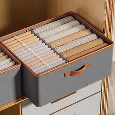 the drawers are organized with folded papers and ties