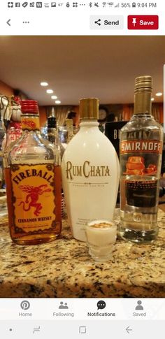 bottles of rumchata sit on a counter in a bar with other liquors