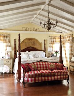 a bed sitting in the middle of a bedroom next to a window