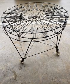 a large metal structure sitting on top of a cement floor