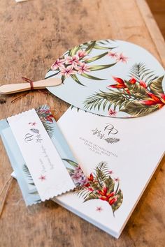 the wedding stationery is laid out on top of the wooden table, ready for guests to arrive