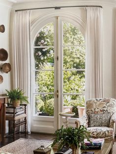 a living room filled with furniture and a large window